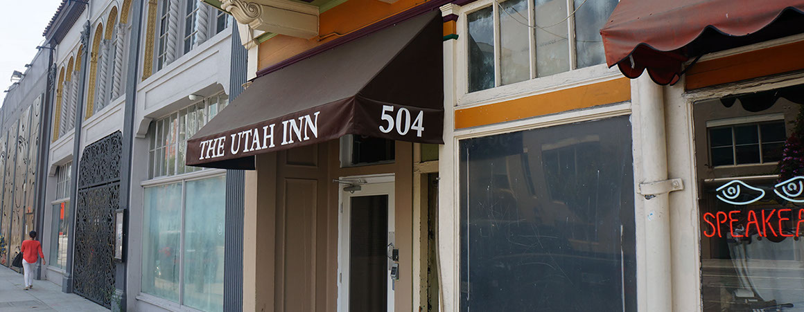 A storefront with a brown awning reading 'THE UTAH INN' and the number '504'.