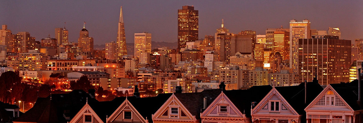 a cityscape at dusk with skyscrapers and buildings lit up